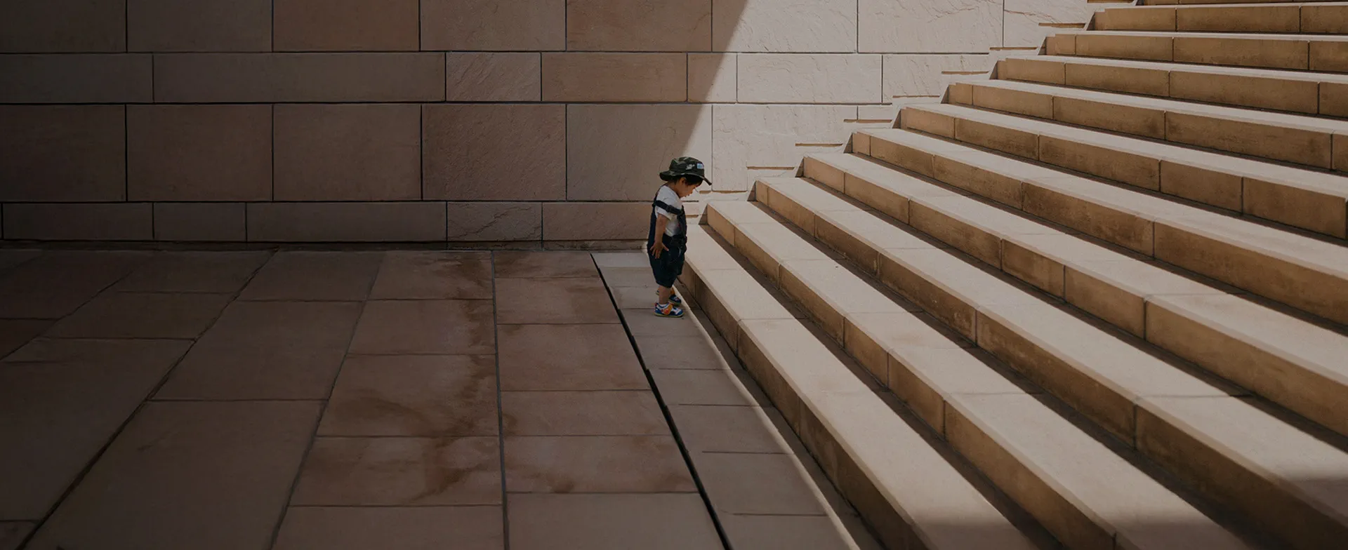A boy at the bottom of a stone stairway